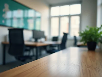 Modern Office Interior With Wooden Desk And Blurred Background