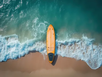 Aerial View Of A Surfboard On A Sandy Beach