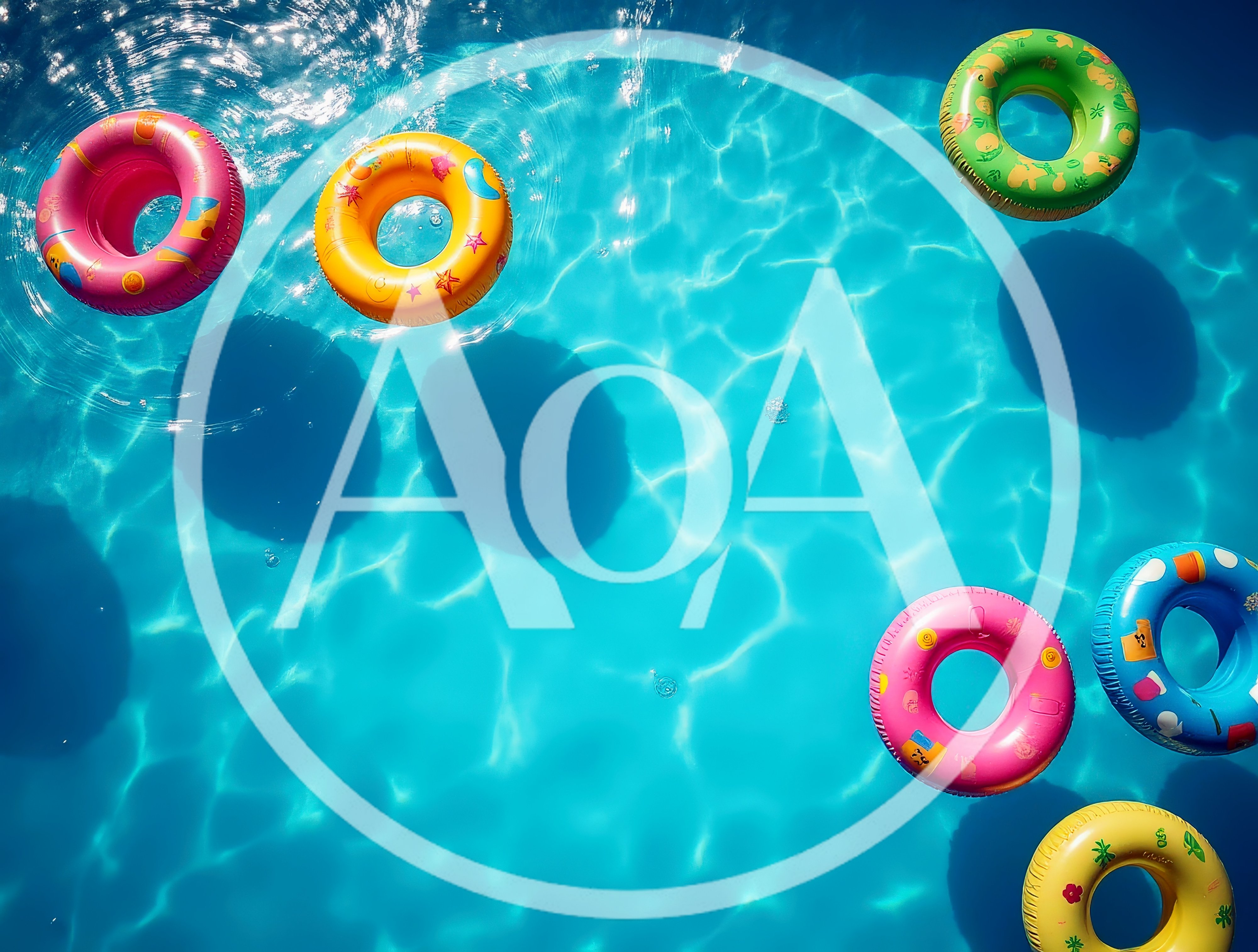 Colorful Inflatable Pool Rings Floating In Blue Water