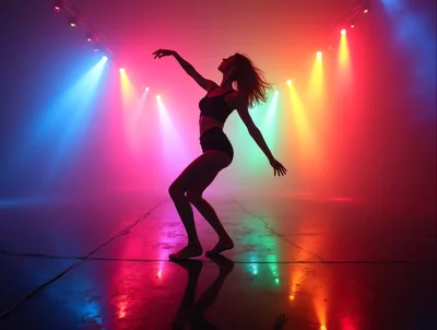Silhouette Of A Female Dancer In Colorful Stage Lights
