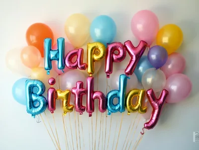Happy Birthday Foil Balloons Against A White Background