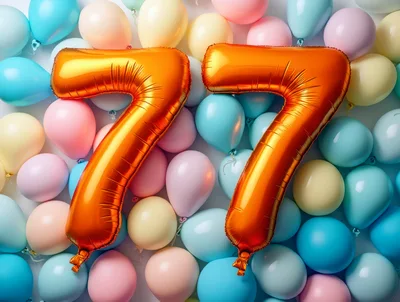 Gold Number 77 Balloons on Pastel Background