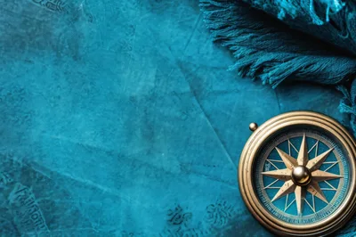 Vintage Brass Compass On Textured Blue Map Background