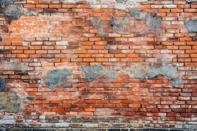 Weathered Red Brick Wall With Patches Of Plaster