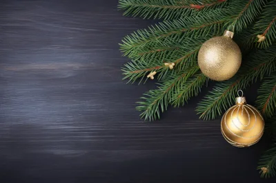 Christmas Ornaments and Pine Branches on Dark Wood