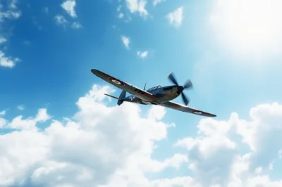 Vintage Supermarine Spitfire Fighter Plane Flying In Blue Sky