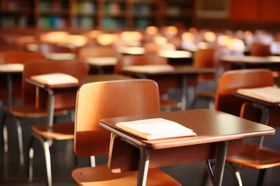 Empty Wooden School Desks In A Library Classroom