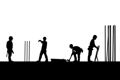 Silhouettes Of Construction Workers On A Building Site