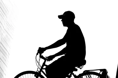 Silhouette Of A Man Riding A Bicycle