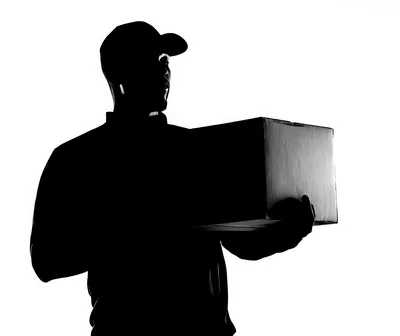 Silhouette Of A Delivery Person Holding A Package