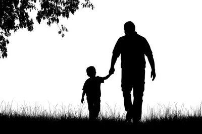 Silhouette Of A Father And Son Walking Together