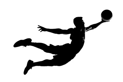Silhouette Of A Basketball Player Jumping For A Dunk