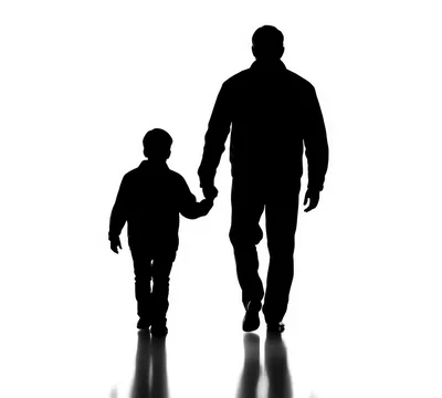 Silhouette Of A Father And Son Walking Together