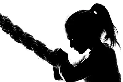 Silhouette Of A Young Woman Pulling A Thick Rope