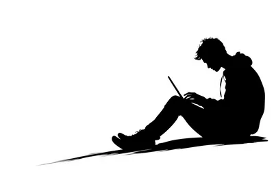 Silhouette Of A Young Man Using A Laptop