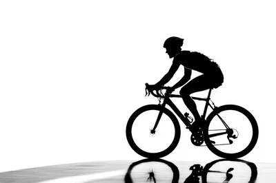 Silhouette Of A Cyclist Riding A Road Bike