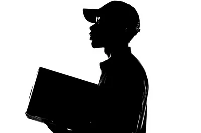 Silhouette Of A Delivery Person Holding A Package