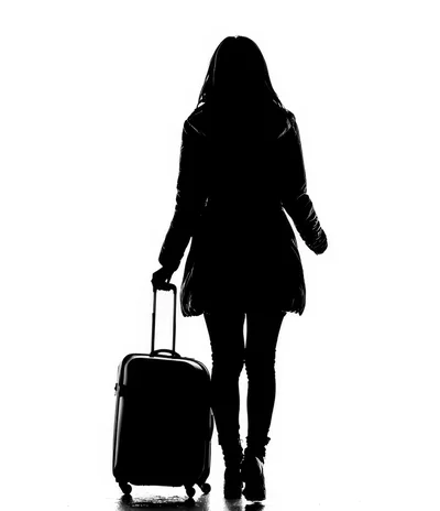 Silhouette of a Woman Walking with Luggage