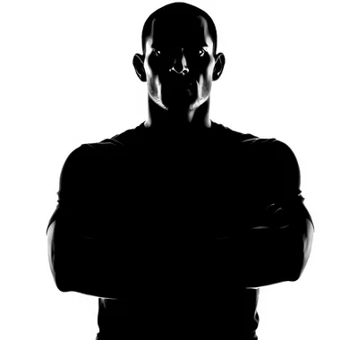 Silhouette Of A Muscular Man With Crossed Arms