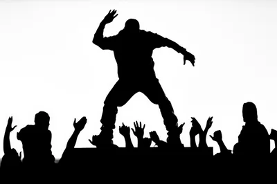 Silhouette Of A Performer On Stage Before A Crowd