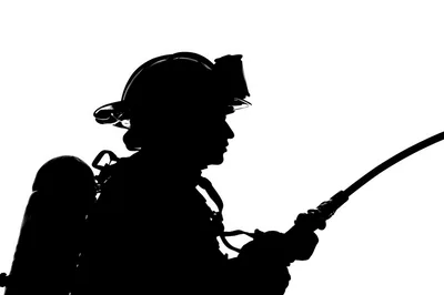 Silhouette Of A Firefighter Holding A Hose