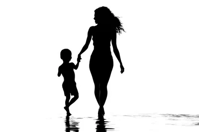 Silhouette of Mother and Son Walking Together