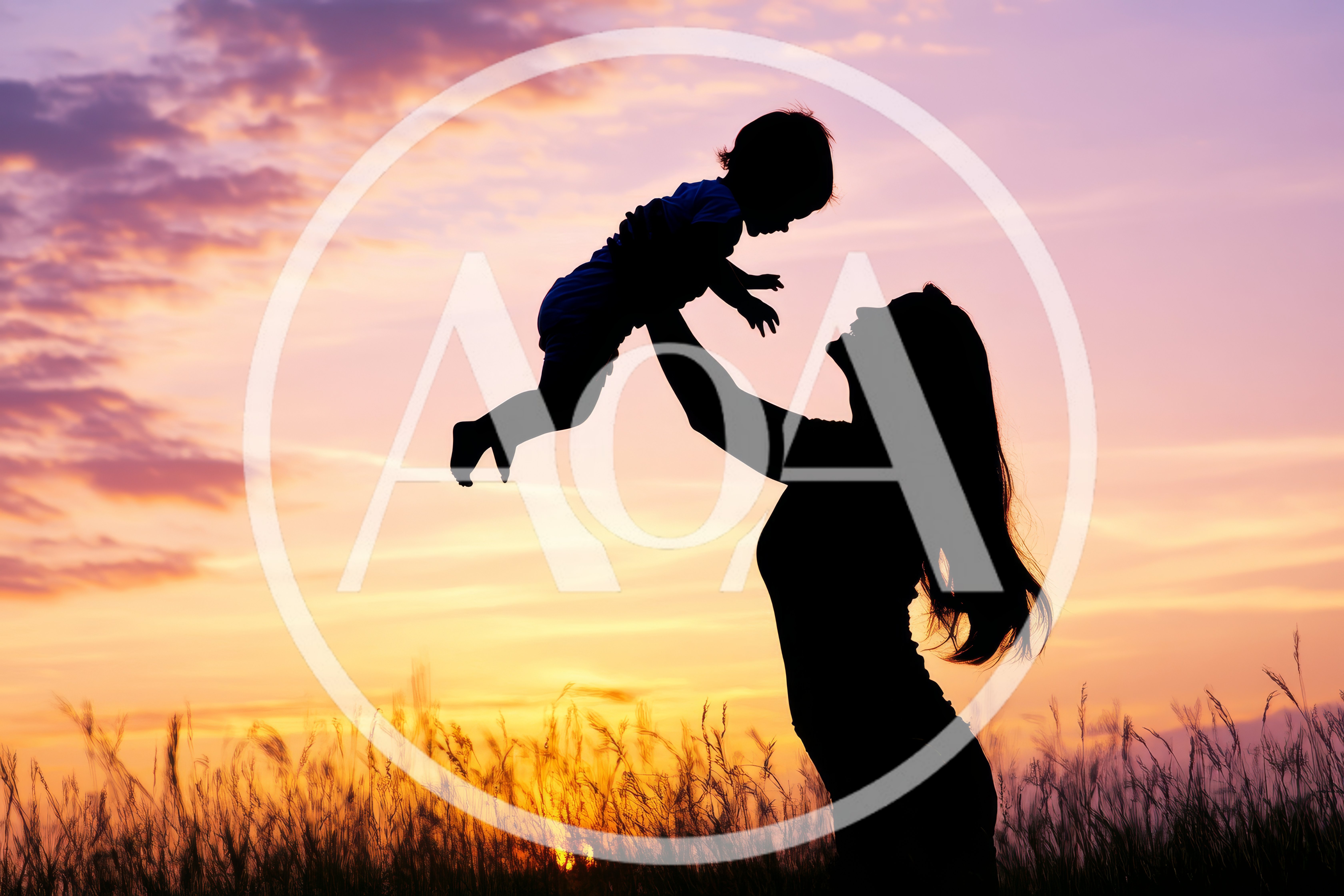 Mother Lifting Her Baby Against A Sunset Sky