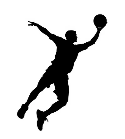 Silhouette Of A Basketball Player Jumping For A Dunk