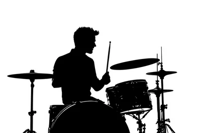 Silhouette Of A Drummer Playing A Drum Kit