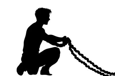 Silhouette Of A Man Exercising With Battle Ropes