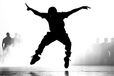 Silhouette Of A Breakdancer Performing An Aerial Jump