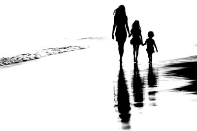 Mother And Two Daughters Walking On Beach Silhouette