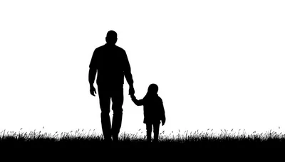 Silhouette Of A Father Walking With His Young Child