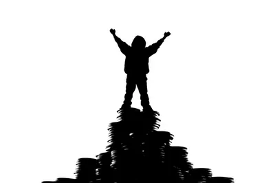 Silhouette Of A Child Standing On A Coin Stack