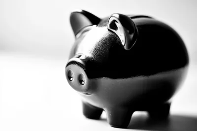 Black Piggy Bank On A White Surface