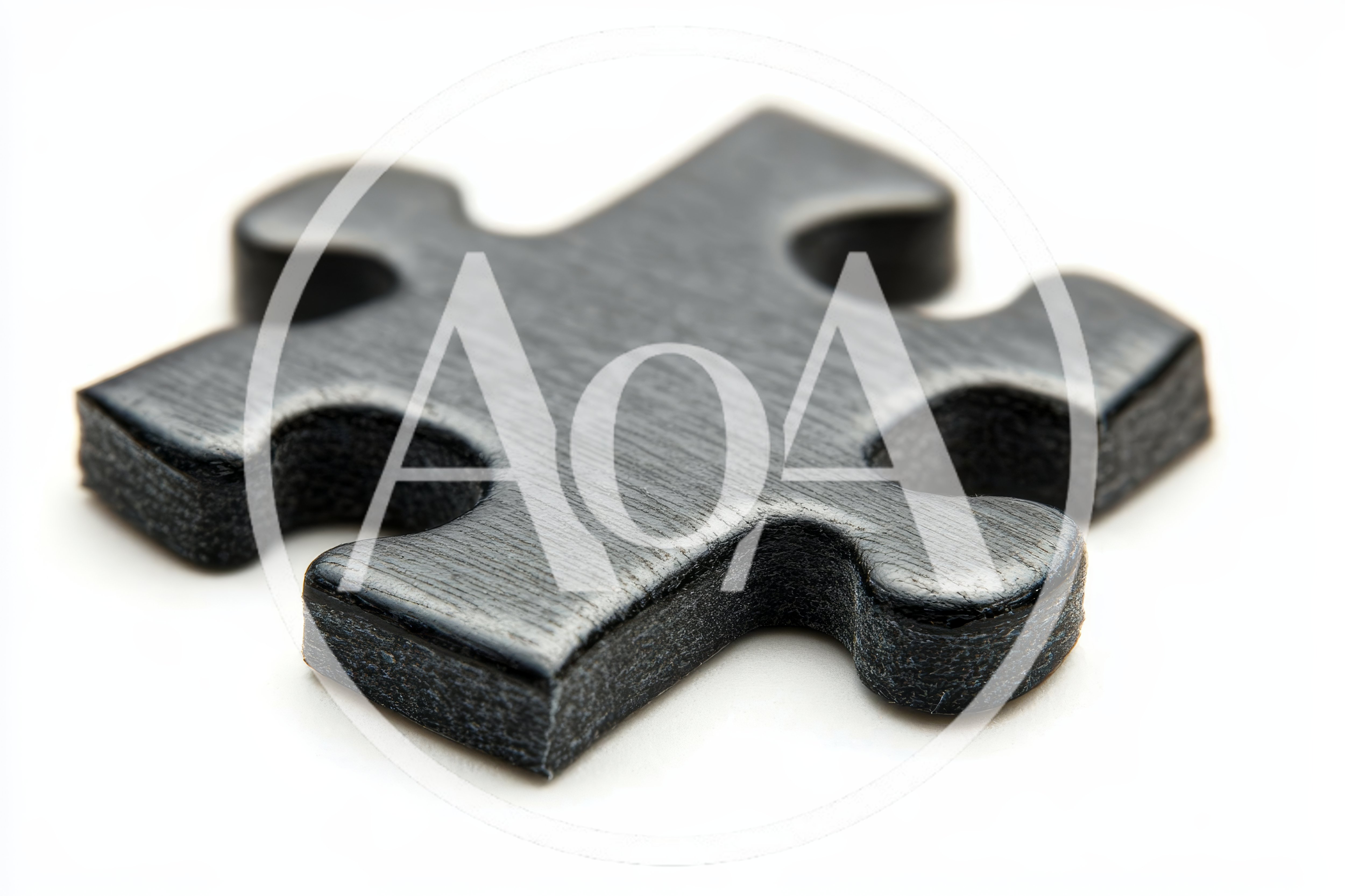 Single Black Jigsaw Puzzle Piece on White Background