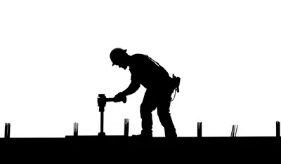 Silhouette Of A Construction Worker Using A Jackhammer
