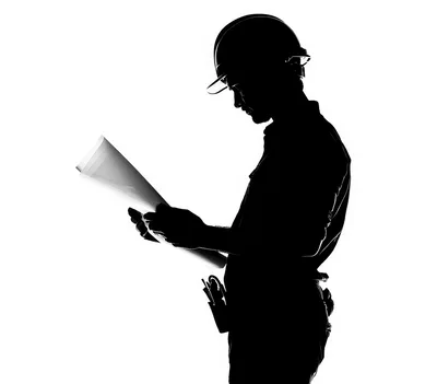 Silhouette Of A Construction Worker Reviewing Blueprints
