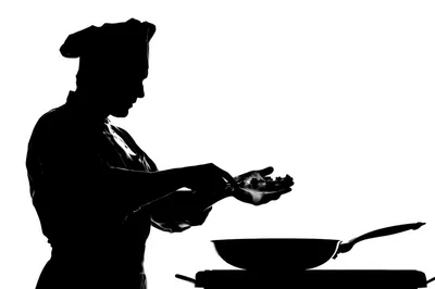 Silhouette Of A Professional Chef Cooking In A Kitchen