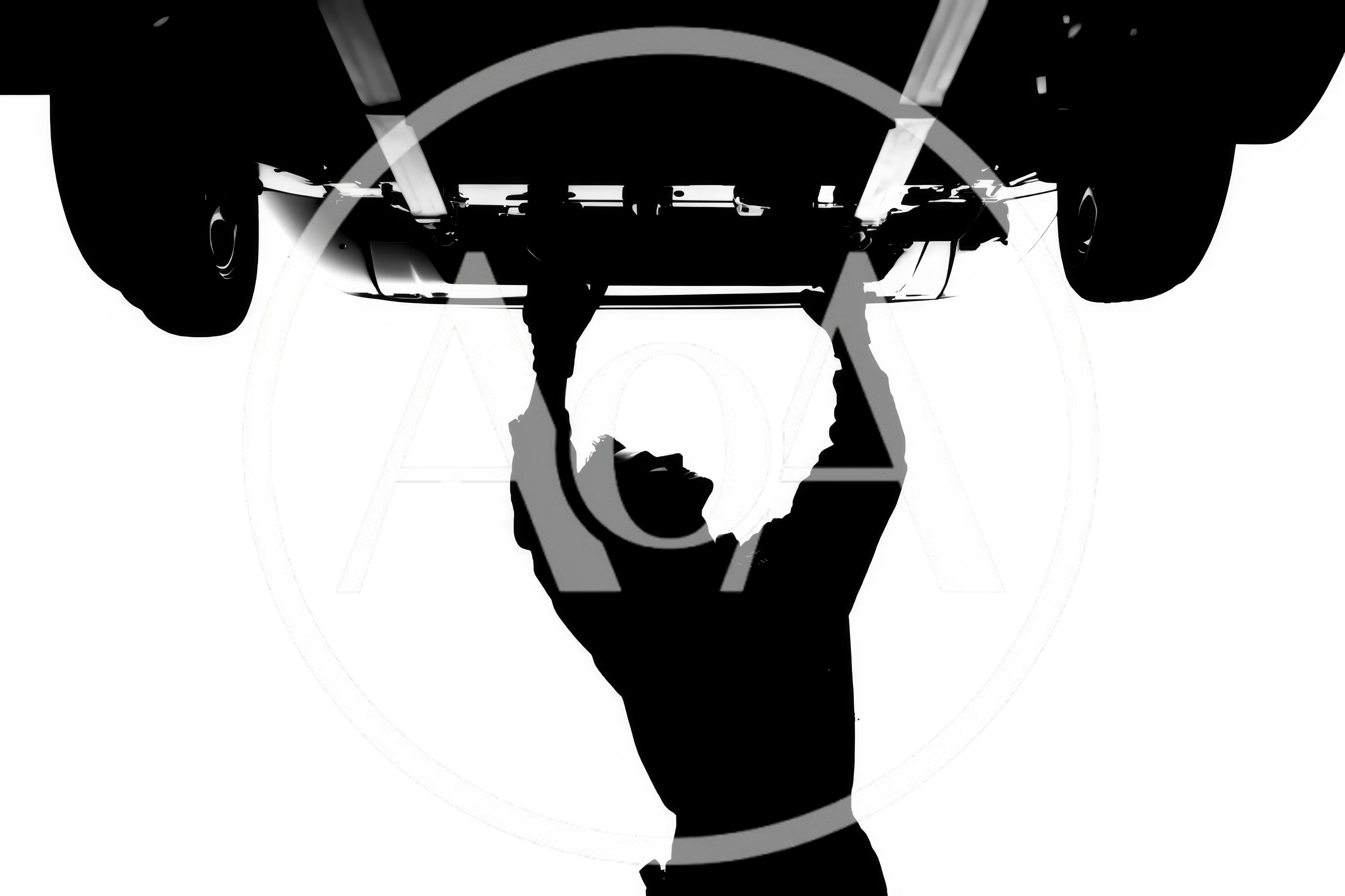 Silhouette Of A Mechanic Working Under A Car