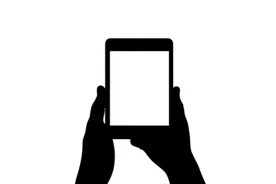Silhouette Of Hands Holding A Tablet Device