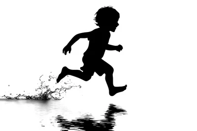 Silhouette Of A Child Running Through Water