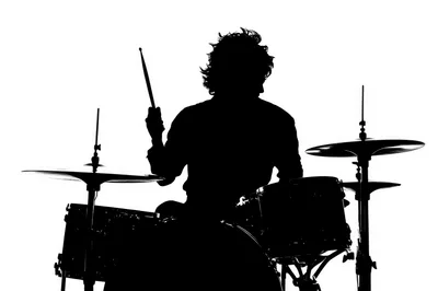Silhouette Of A Drummer Playing Drums
