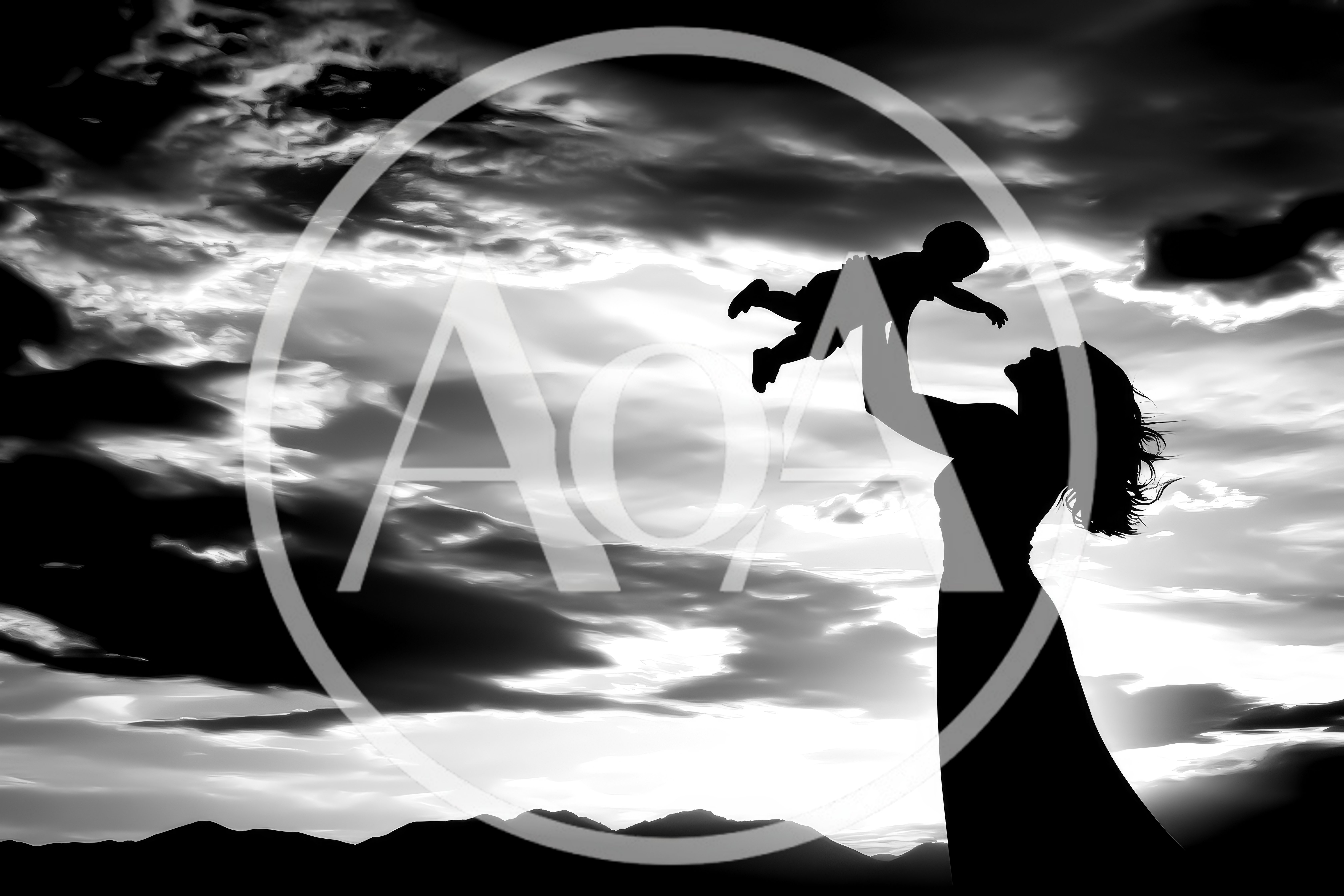 Silhouette Of A Mother Lifting Her Baby At Sunset