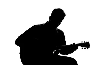 Silhouette Of A Man Playing Acoustic Guitar