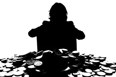Silhouette Of A Business Person Behind A Pile Of Coins