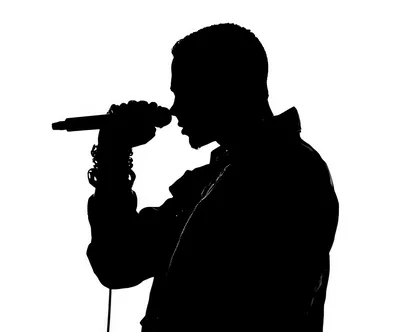 Silhouette Of A Male Singer Performing With A Microphone