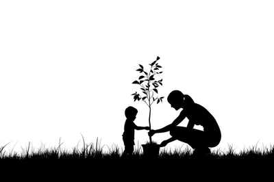 Silhouette of Mother and Child Planting a Tree