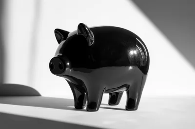 Black Ceramic Piggy Bank On White Surface