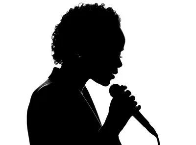 Silhouette Of A Woman Singing Into A Microphone